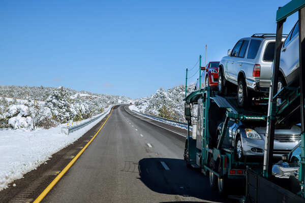 Auto transport driver inspecting a vehicle before loading