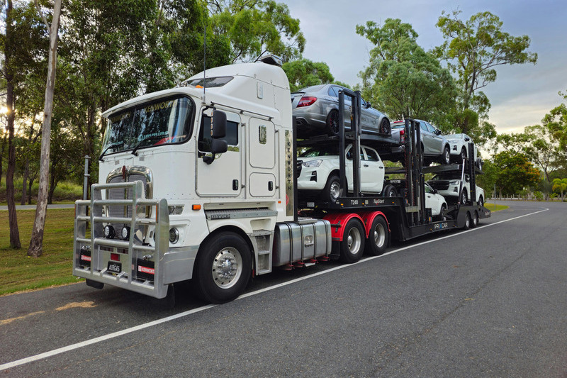 Auto transport truck delivering vehicles on a long highway