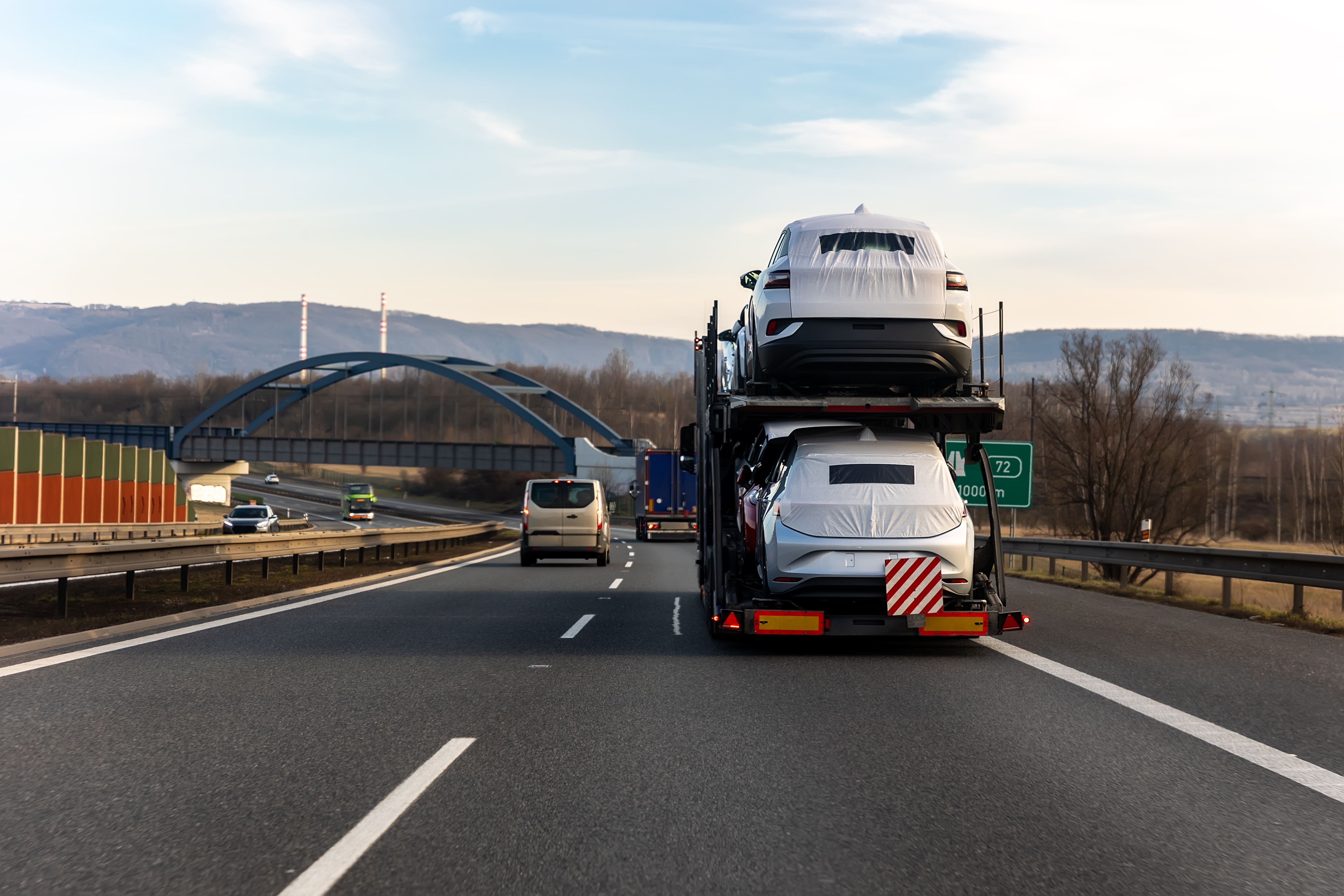 Multi-level auto transport carrier loaded with vehicles on a highway